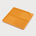 Lick & Chill Silicone Lick Mat in matte marigold-orange on a light neutral background