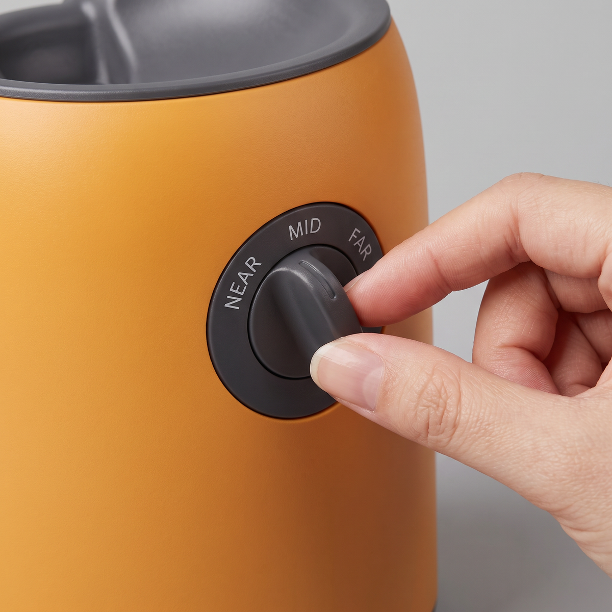 Adjusting the throw-distance dial on the Frenzy Mini ball launcher