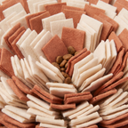 Close-up of kibble tucked in the felt strips of the Forage Snuffle Mat