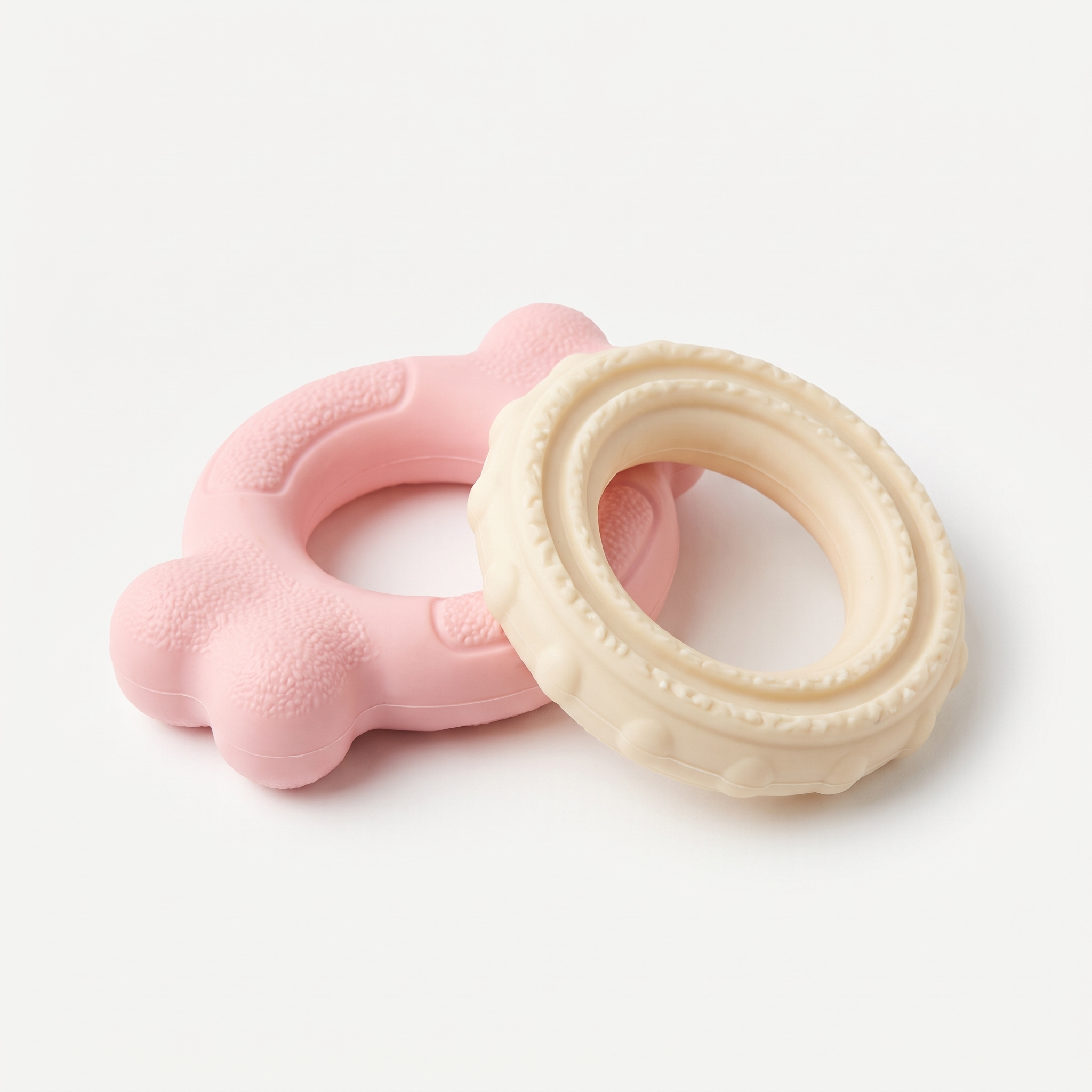 First Chew Soft Ring Set (2-Pack) in soft pastel pink and cream on a light neutral background