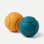 Bounce Fetch Rubber Ball 2-Pack in matte marigold-orange and deep teal on a light neutral background