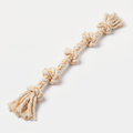 Tug Twist Cotton Rope Toy in natural cream with marigold-orange accents on a light neutral background
