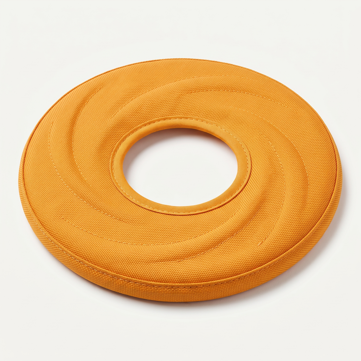 SoftFly Flexible Nylon Frisbee in matte marigold-orange on a light neutral background