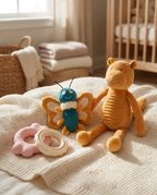 Puppy's First Toy Box items arranged on a soft blanket in a puppy nursery setting