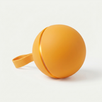 Tailspin Smart Chase Ball in matte marigold-orange with attached fabric tail on white studio background